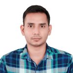Anupam Patel wearing a blue plaid shirt 
