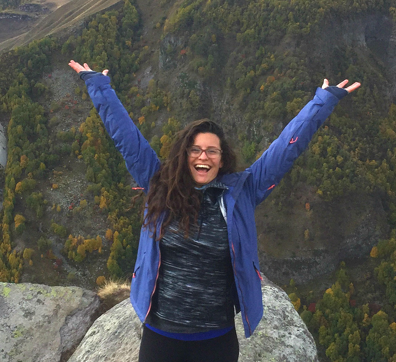 Xiomara Rosenblatt smiling with hands outstretched above her head